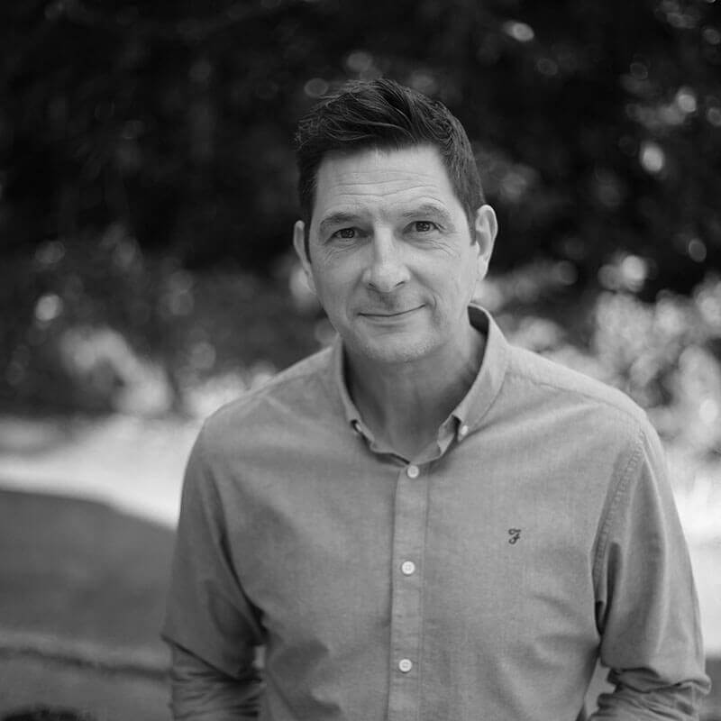 Director Lee Divers smiling in garden landscape